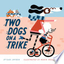 Two dogs on a trike /